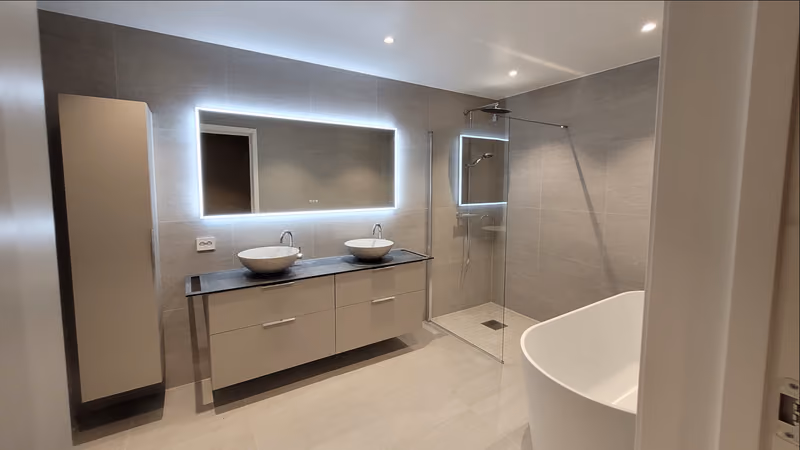 Modern bathroom with a double vanity, shower and freestanding bathtub in an Ålebo home